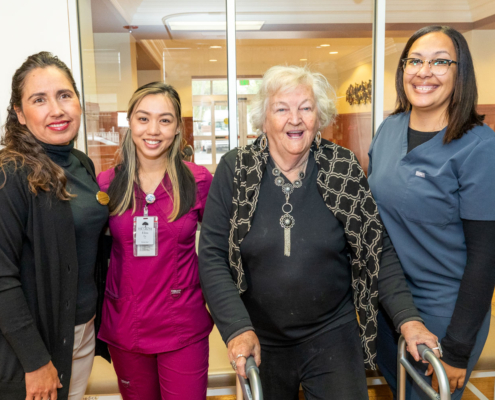 Caretakers and resident together at The Grove senior living